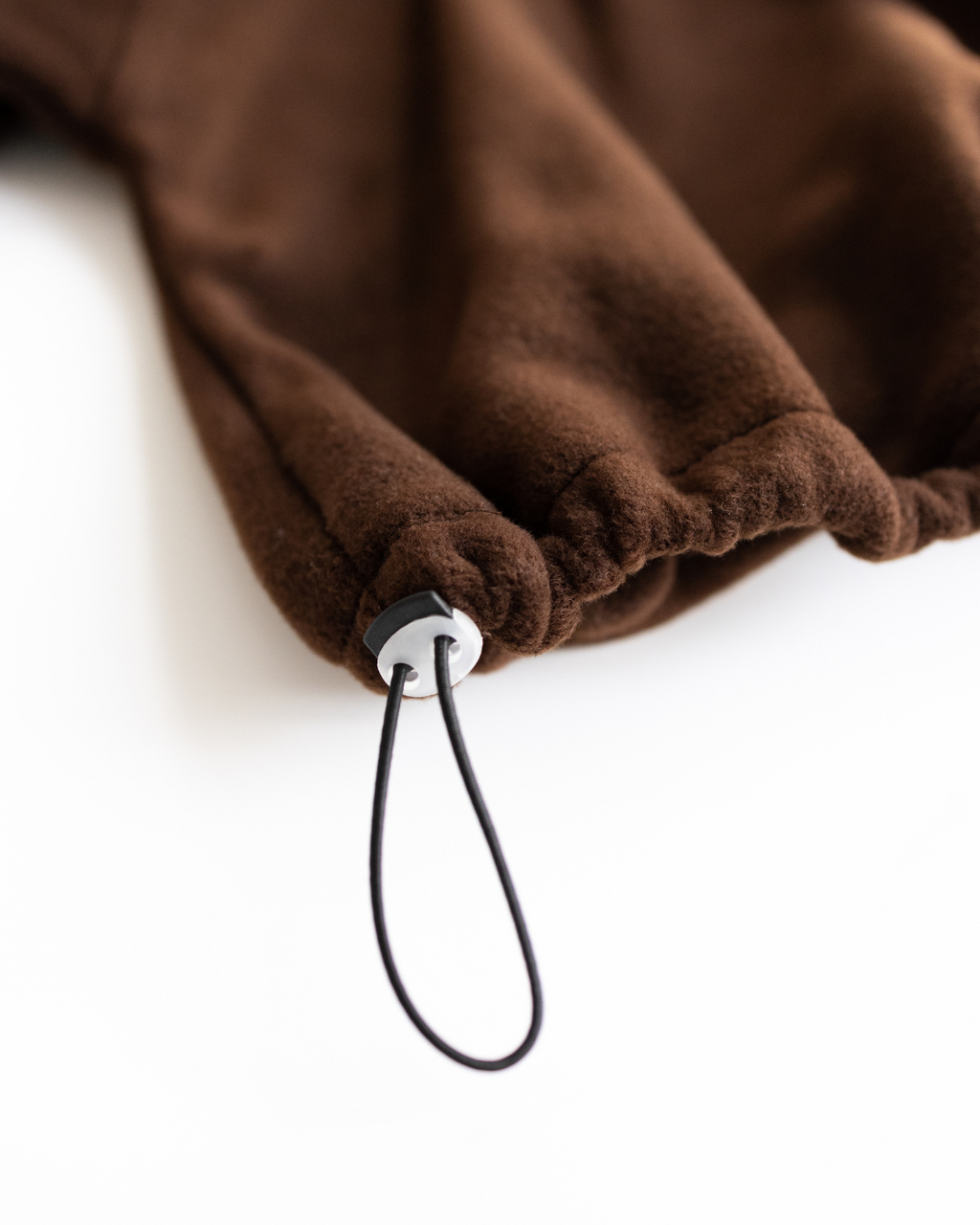 Adjustable drawstring hem detail on fleece pullover