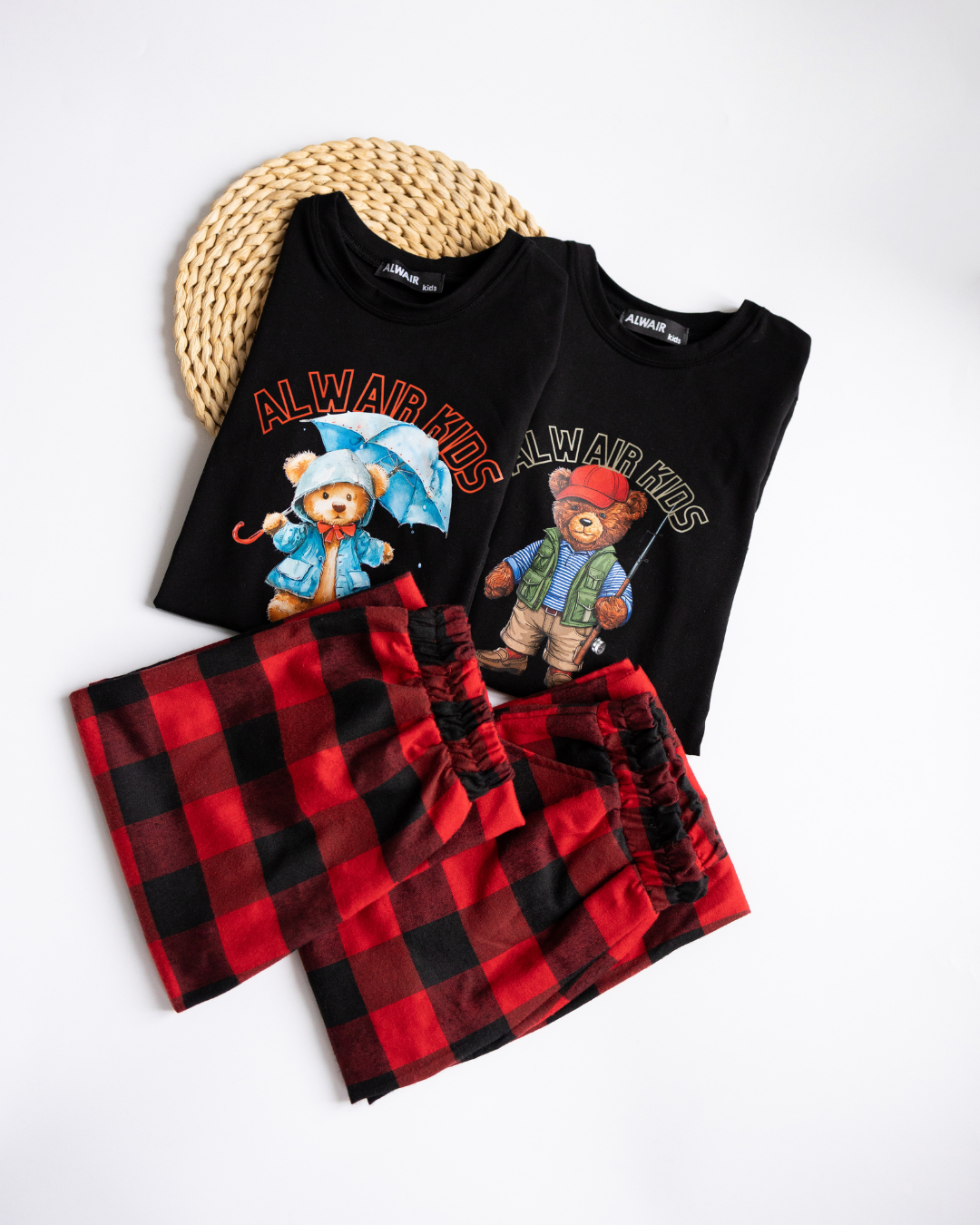 Folded Alwair Kids pajama sets with cute bear prints and plaid pants