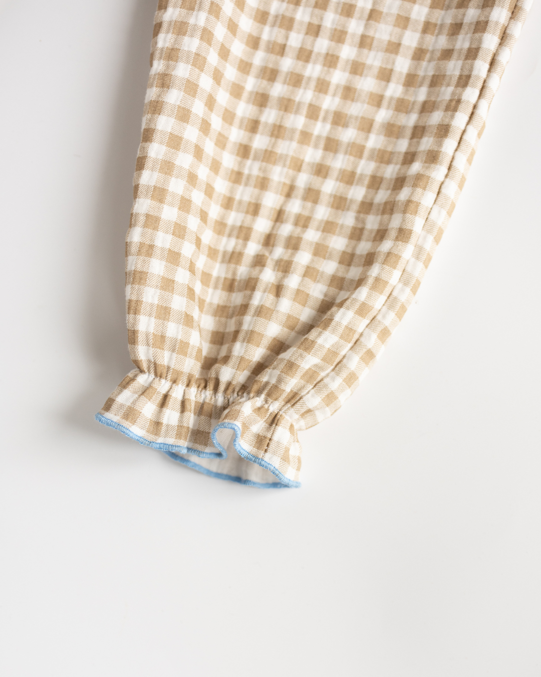 Ruffled cuff detail on beige plaid pajama pants for girls – soft and breathable