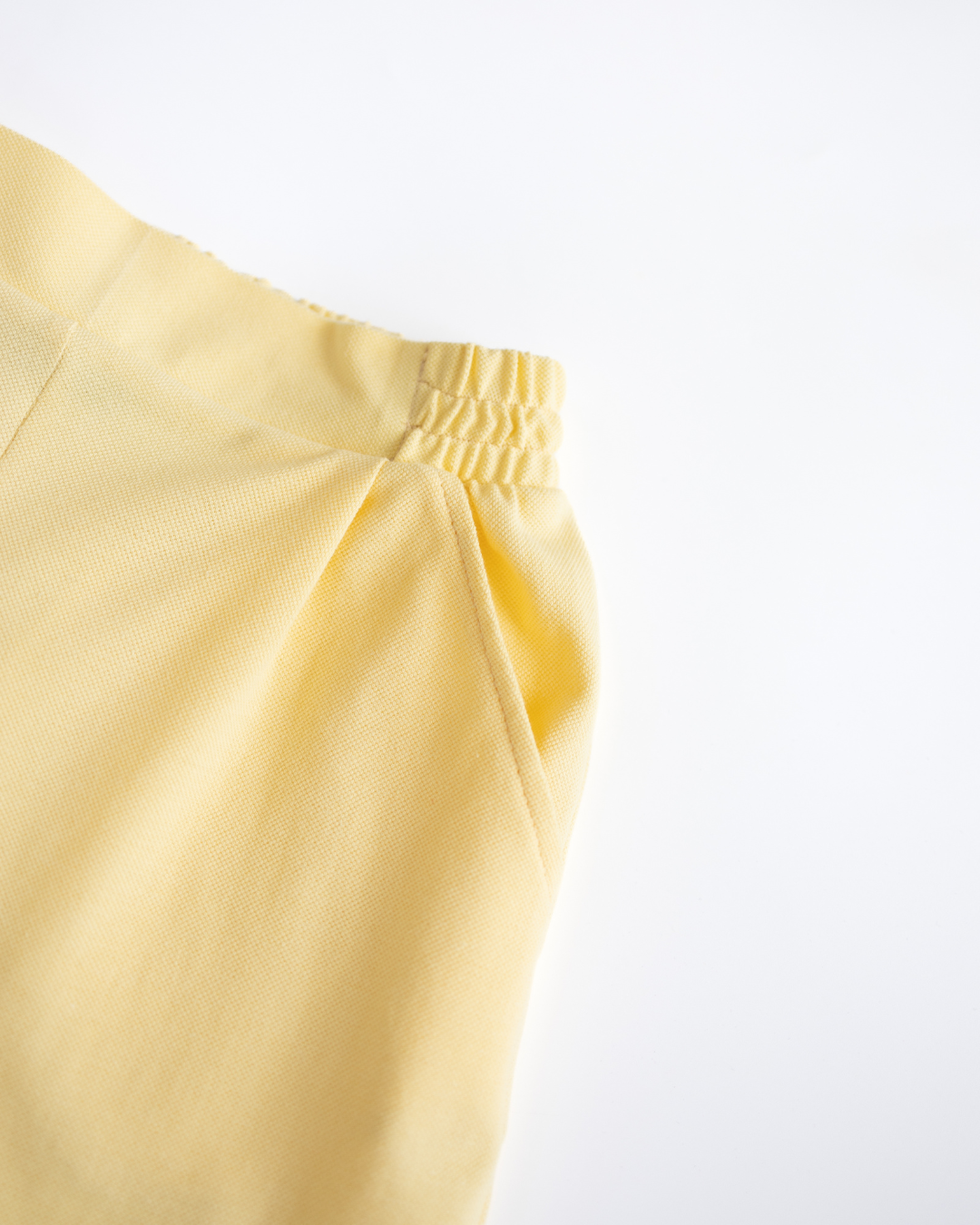 Close-up on pocket and waistband of yellow tennis girls shorts