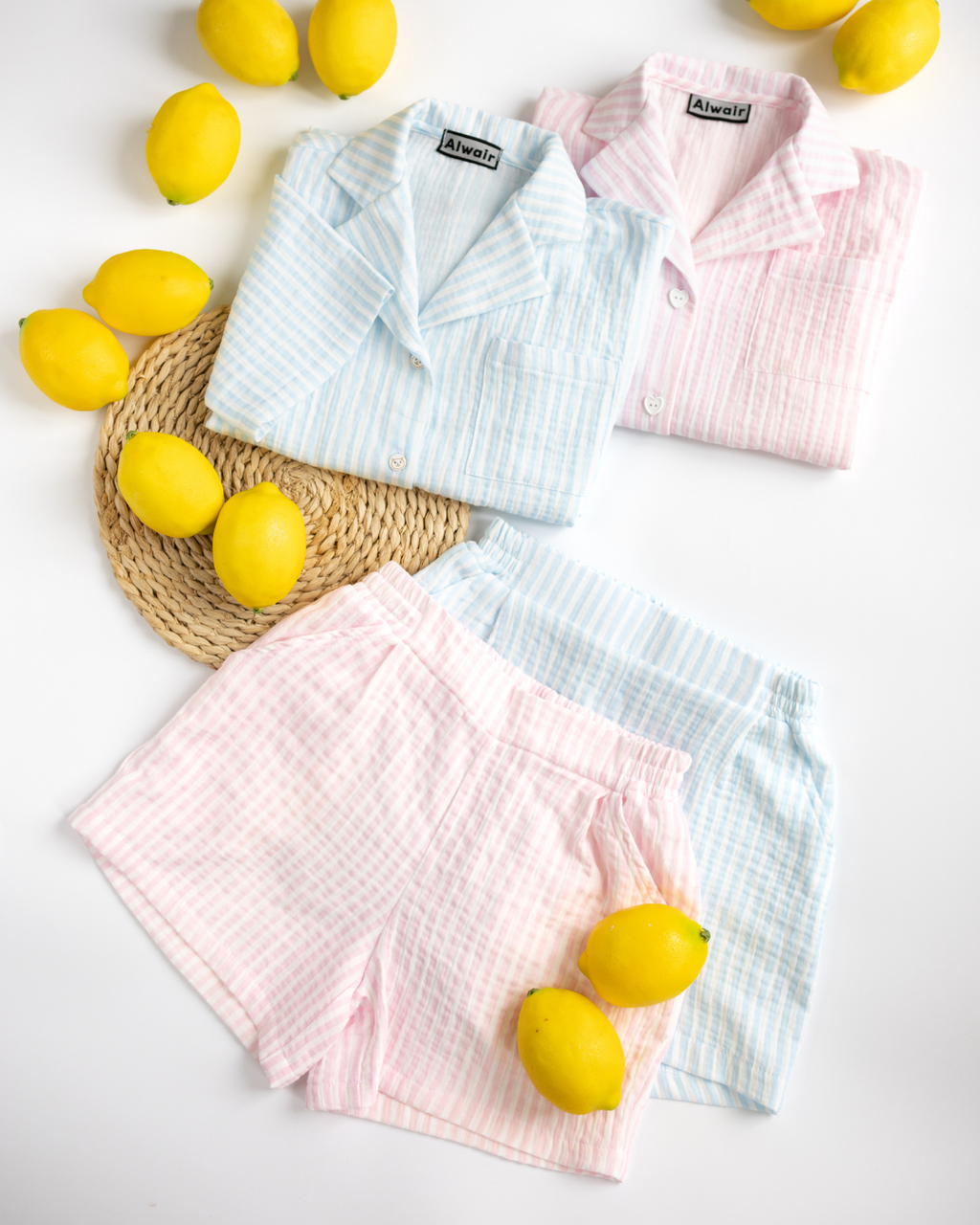 Side-by-side pink and blue kids summer muslin sets by Alwair Kids with lemons