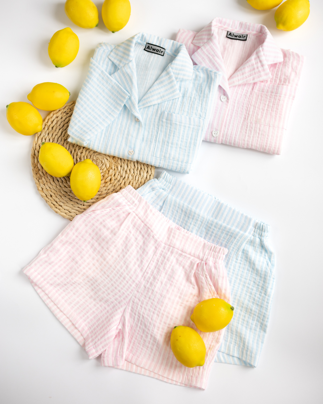 Side-by-side pink and blue kids summer muslin sets by Alwair Kids with lemons