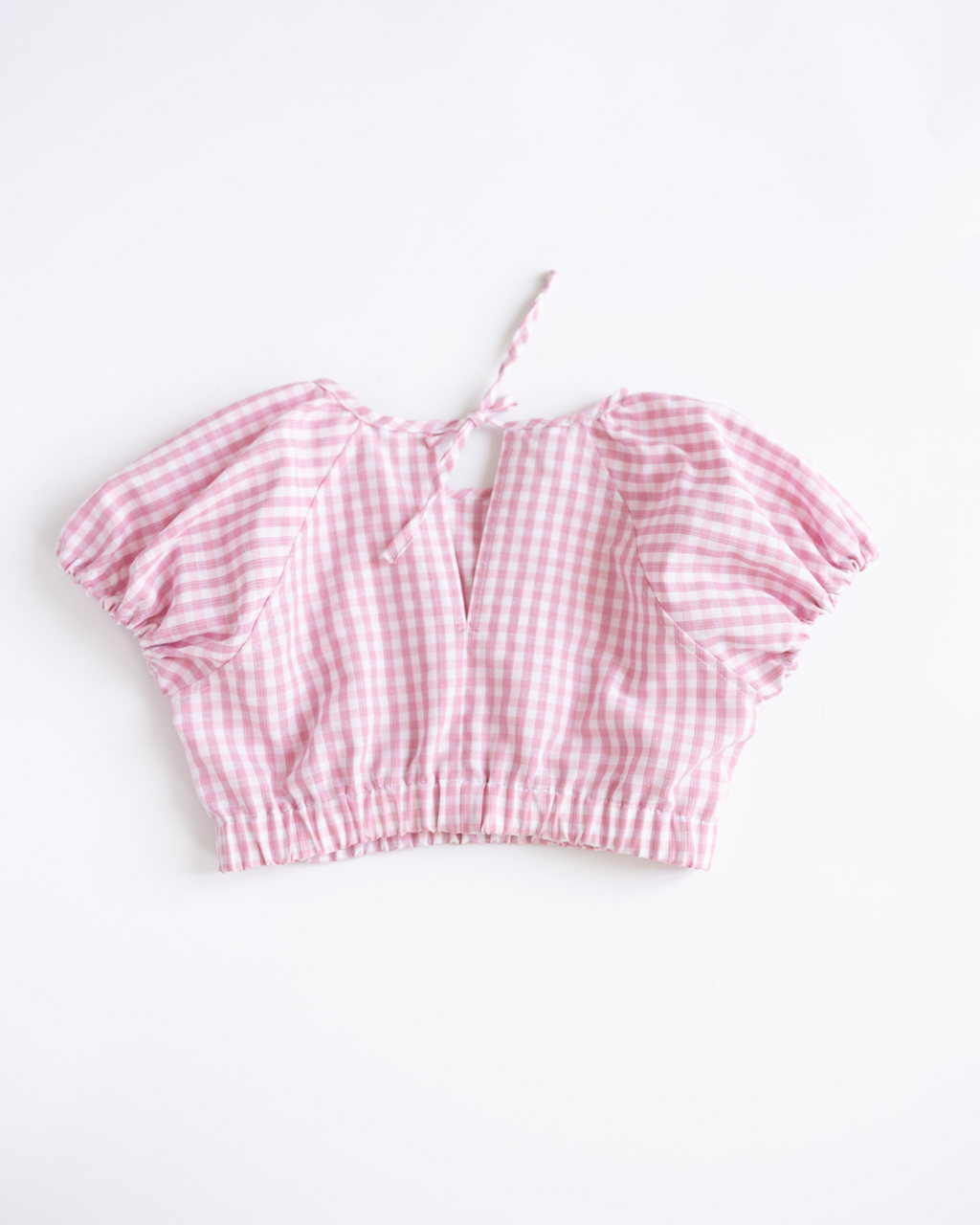 Back view of tie-neck pink gingham top from Blossom outfit Alwair Kids
