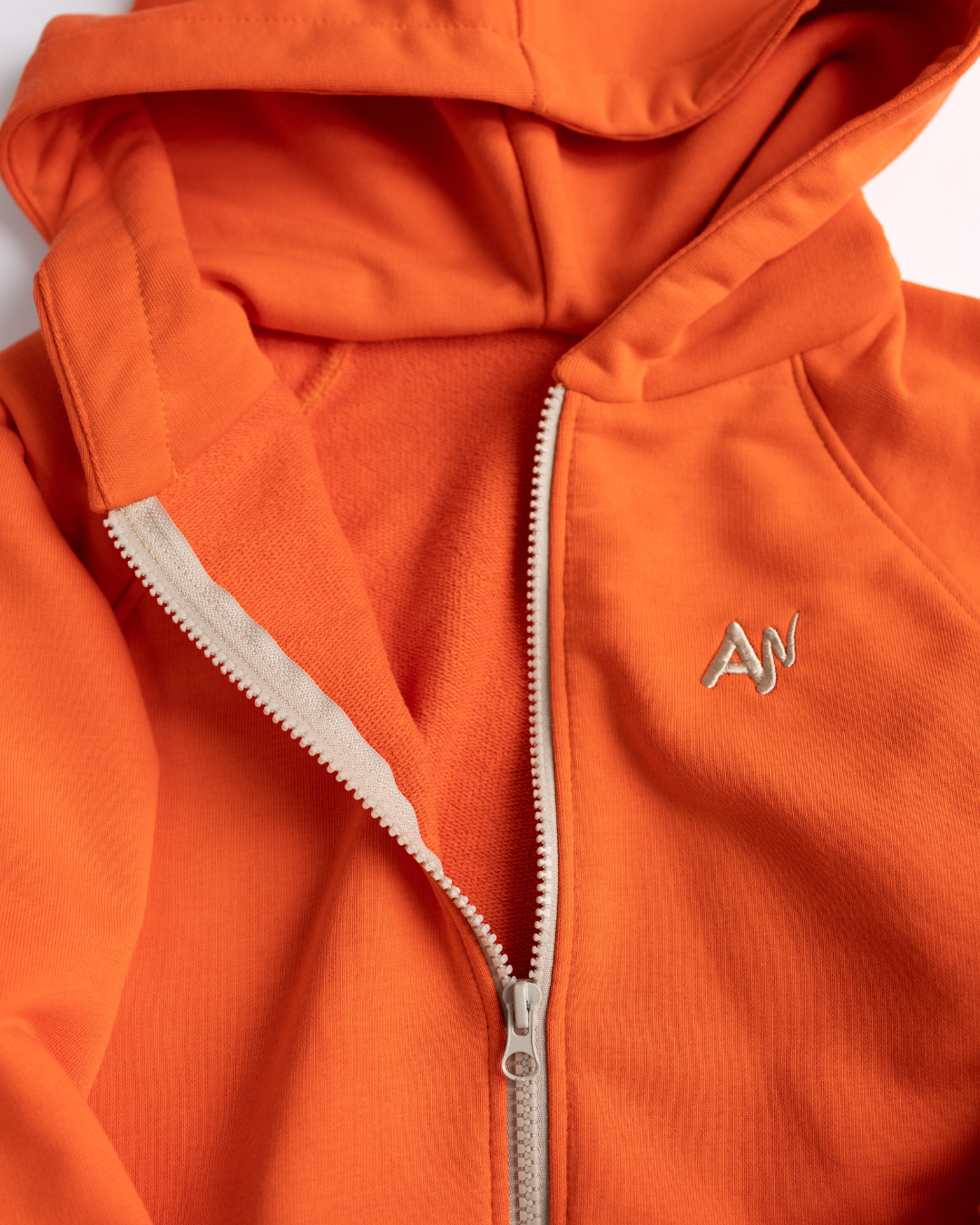 Close-up of zipper and inside texture of orange hoodie