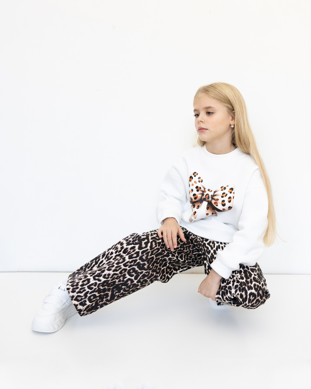 Girl showing off leopard cotton jeans by Alwair Kids in sitting pose