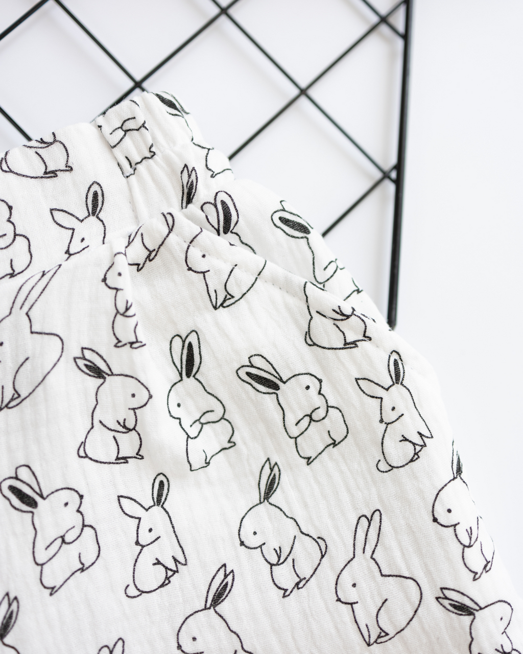 Macro shot of bunny print and muslin texture on girls pajama shorts

