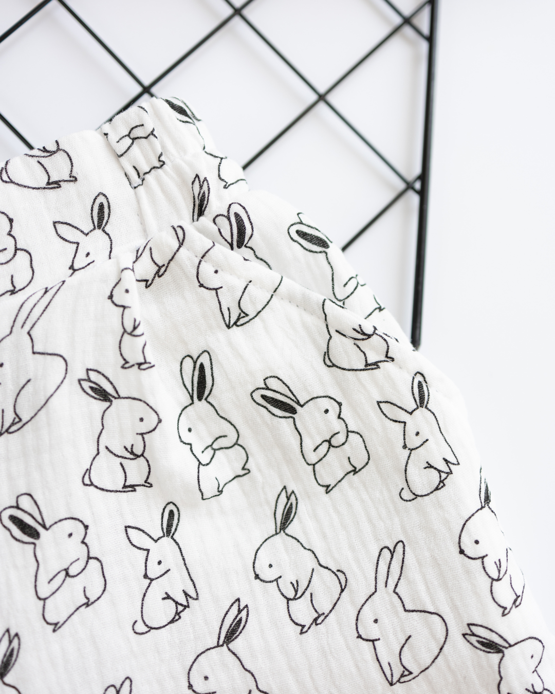Macro shot of bunny print and muslin texture on girls pajama shorts


