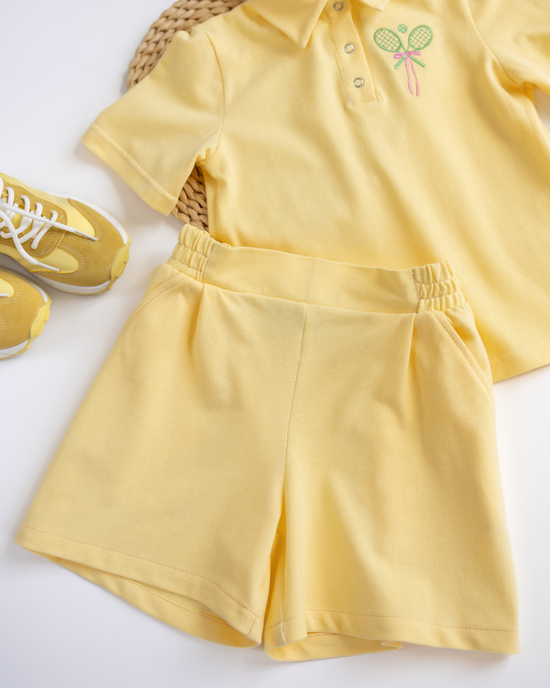 Yellow tennis outfit for girls with matching polo shirt and sneakers