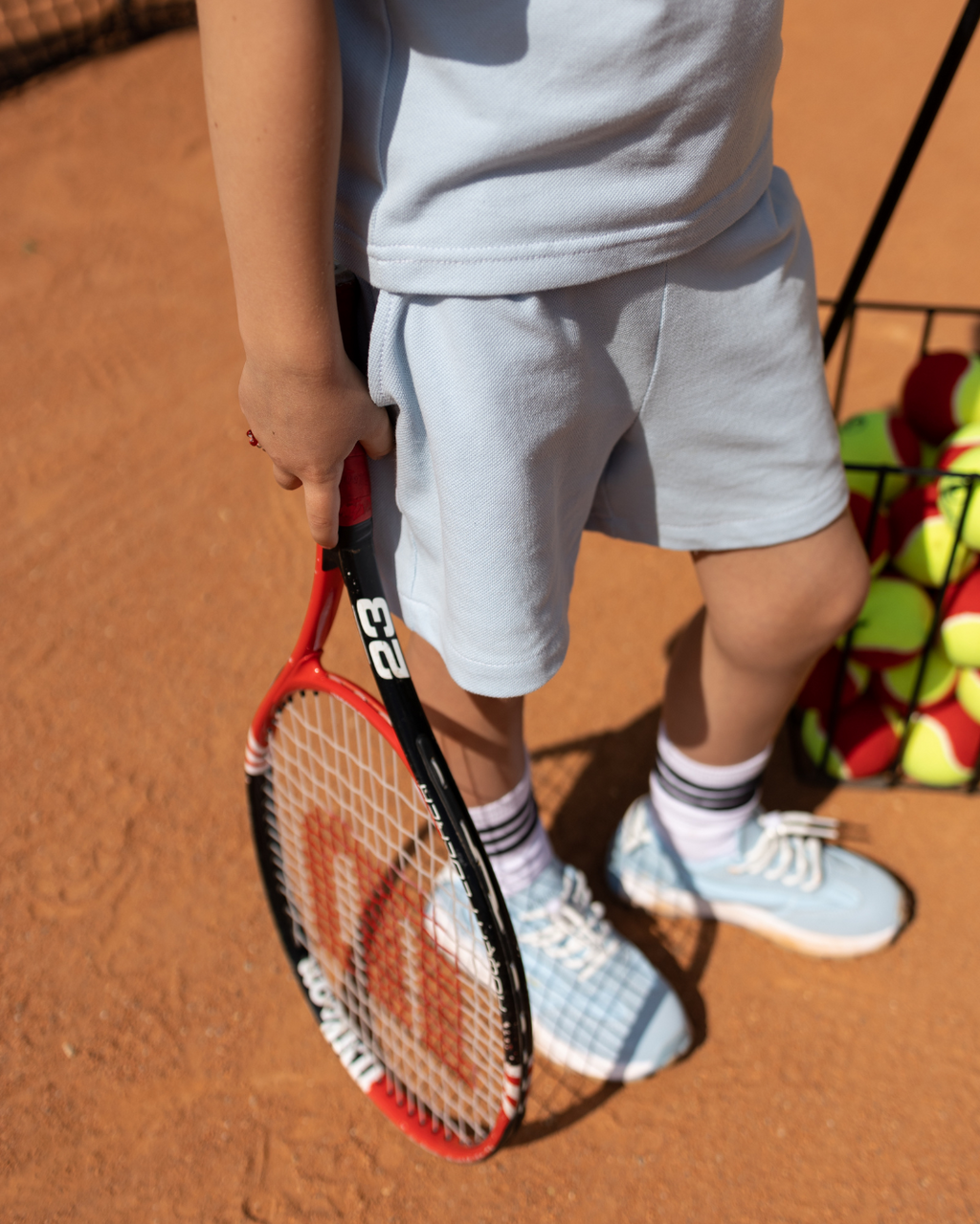 Kids lacoste tennis shorts blue on court by Alwair Kids summer collection