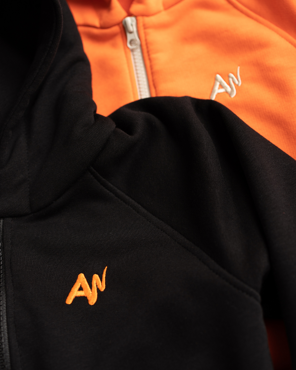 Alwair Kids logo embroidery on black and orange hoodies