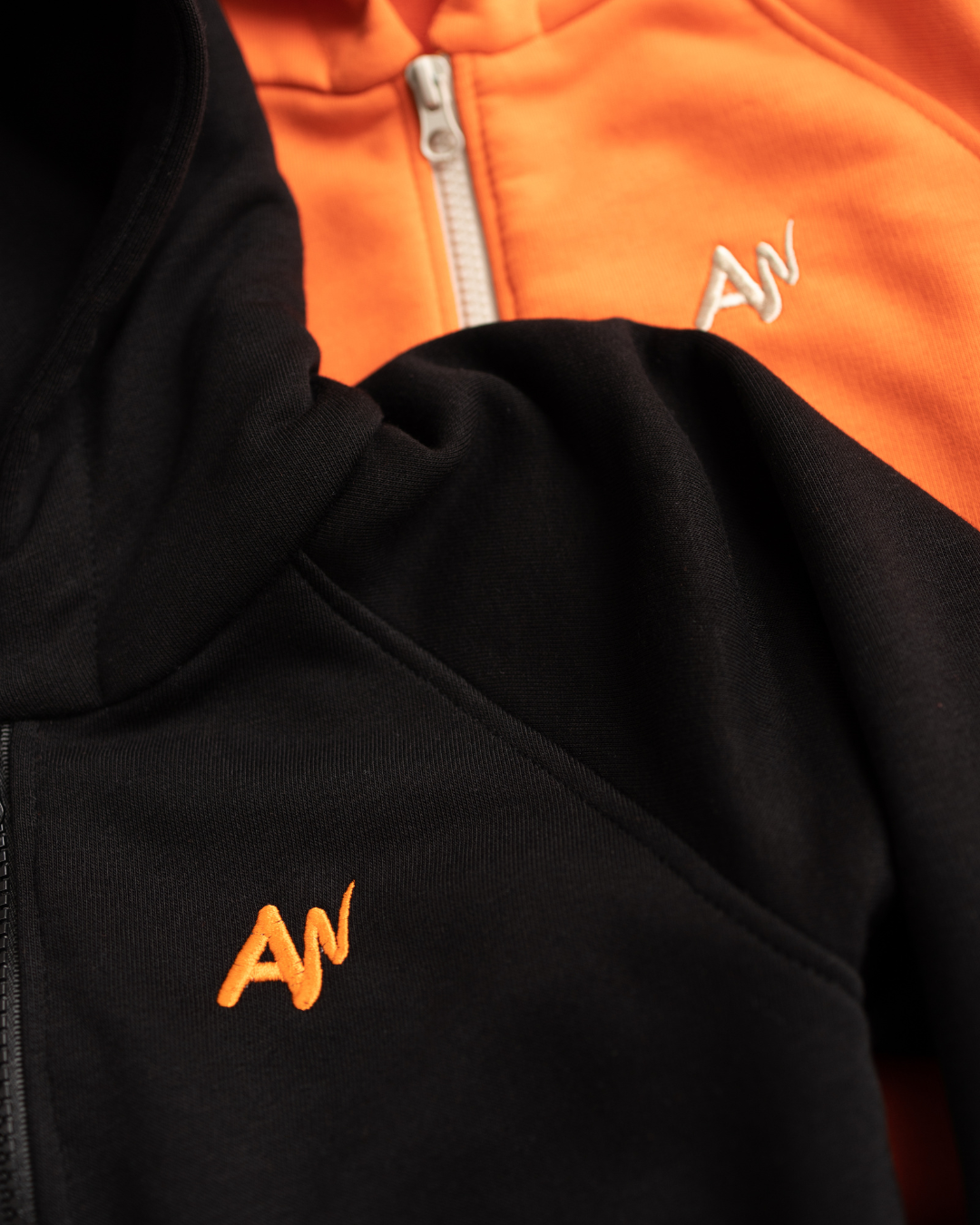 Alwair Kids logo embroidery on black and orange hoodies