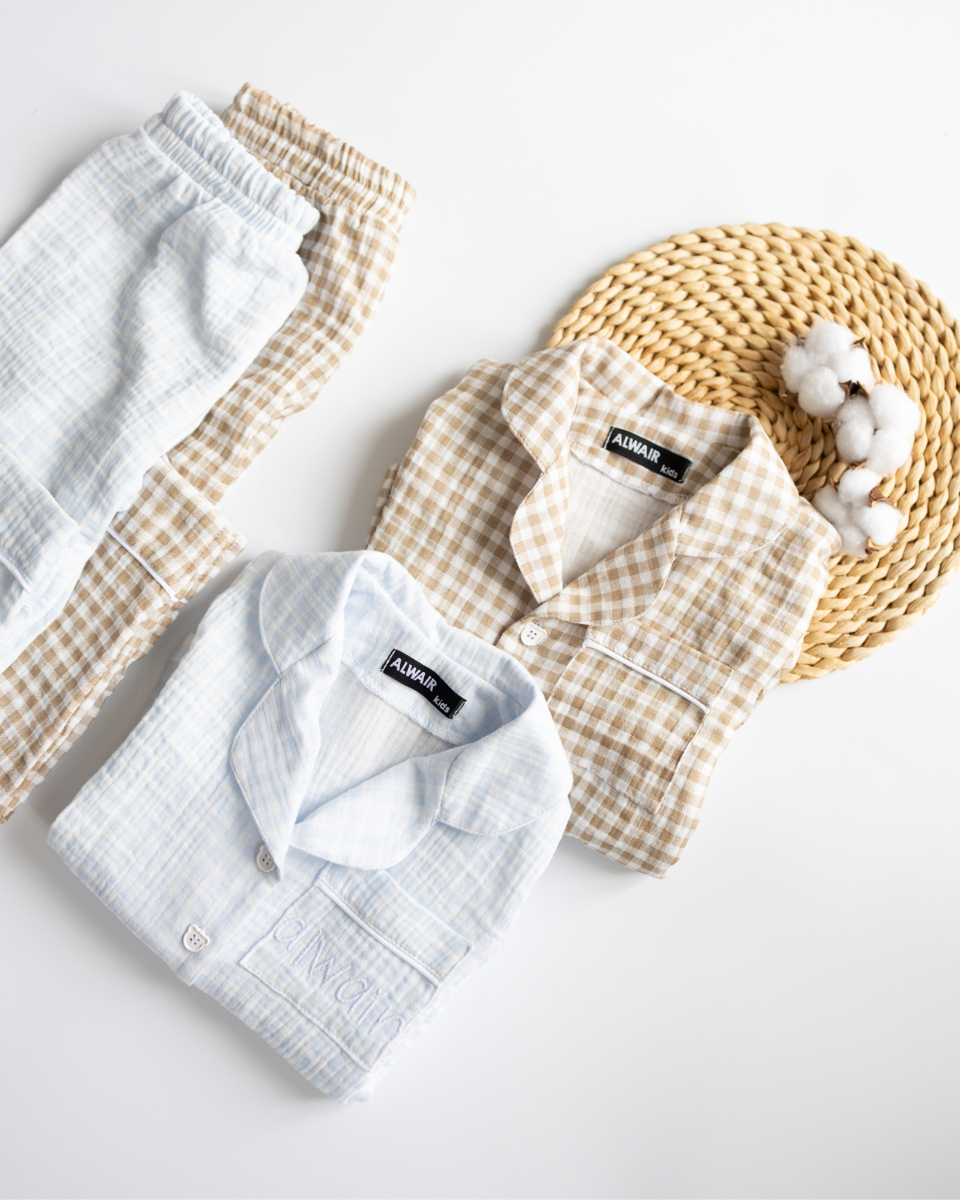 Flat lay of blue check pajama set with soft cotton buds – cozy and aesthetic sleepwear
