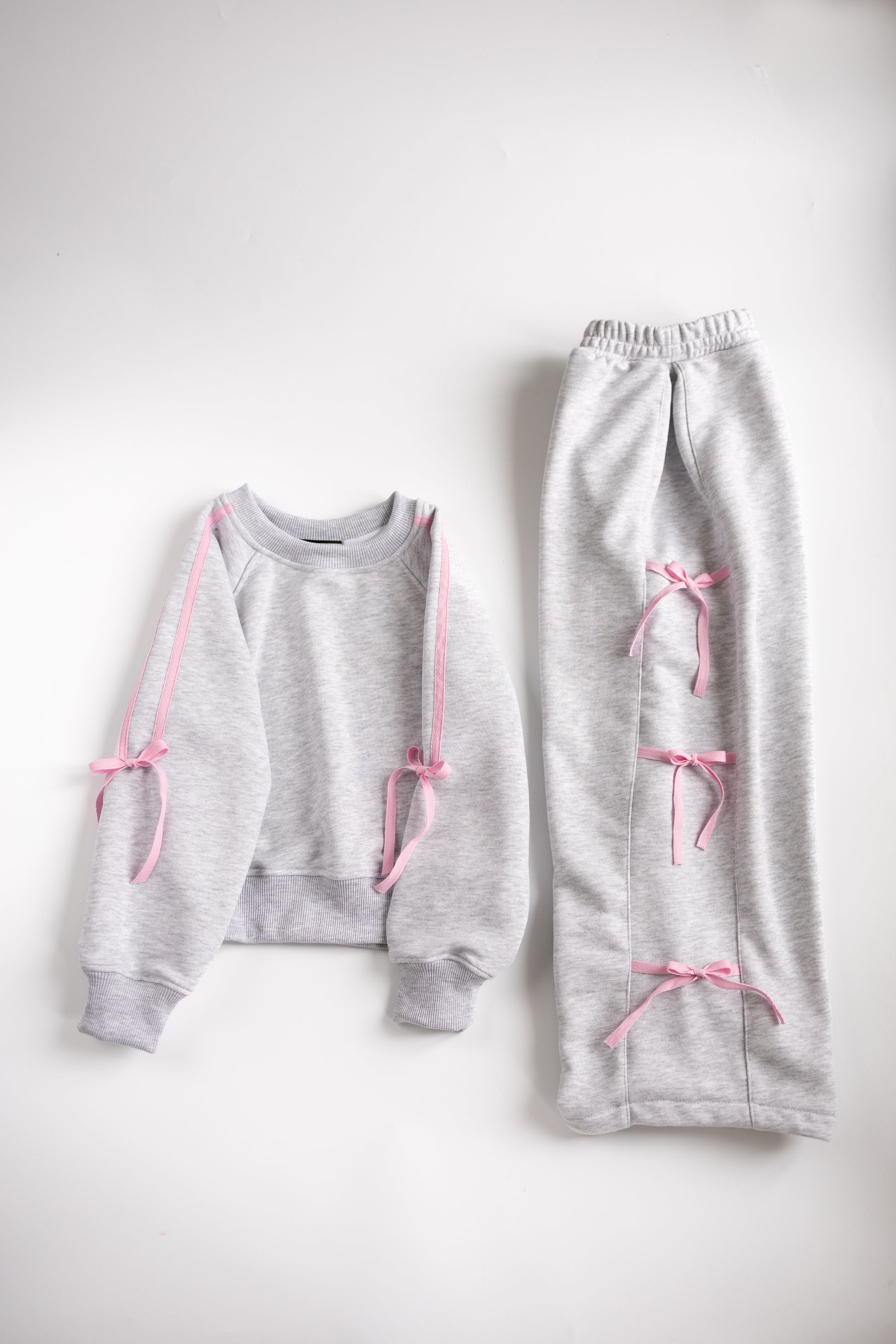 Grey and pink cotton girls tracksuit with bows flat lay