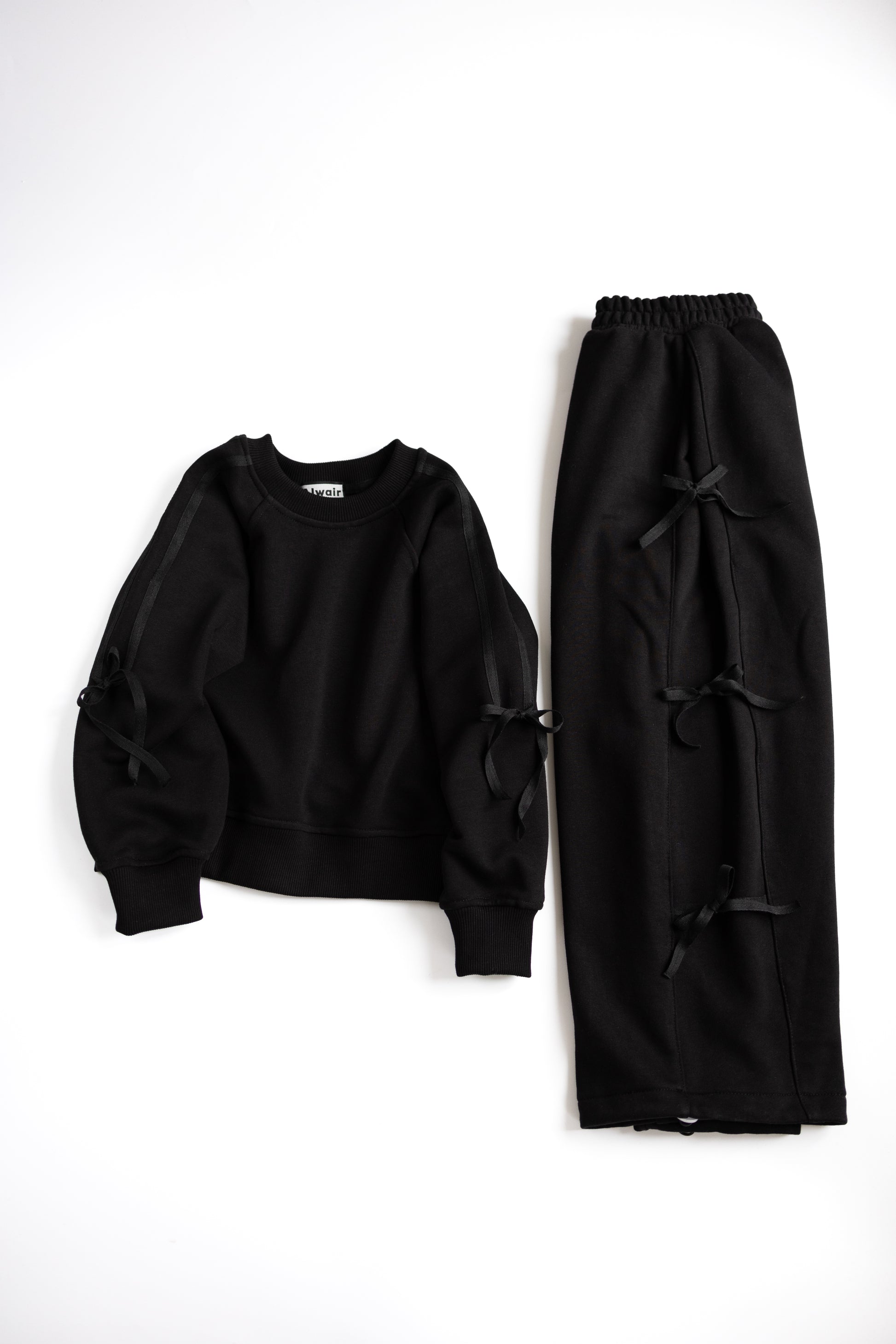 All black girls tracksuit with tonal bows flat lay