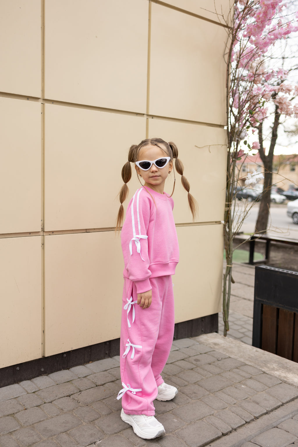 Girl wearing pink bow cotton tracksuit by Alwair Kids