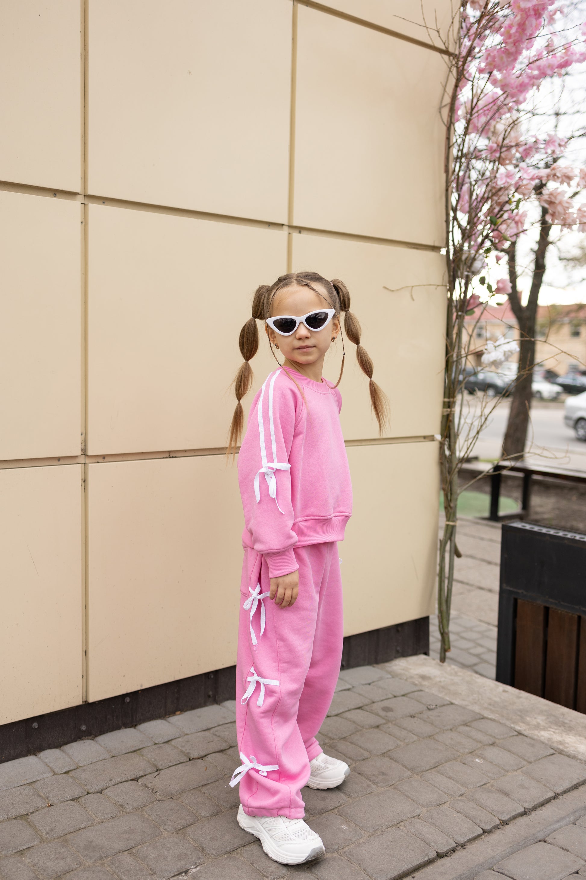 Girl wearing pink bow cotton tracksuit by Alwair Kids