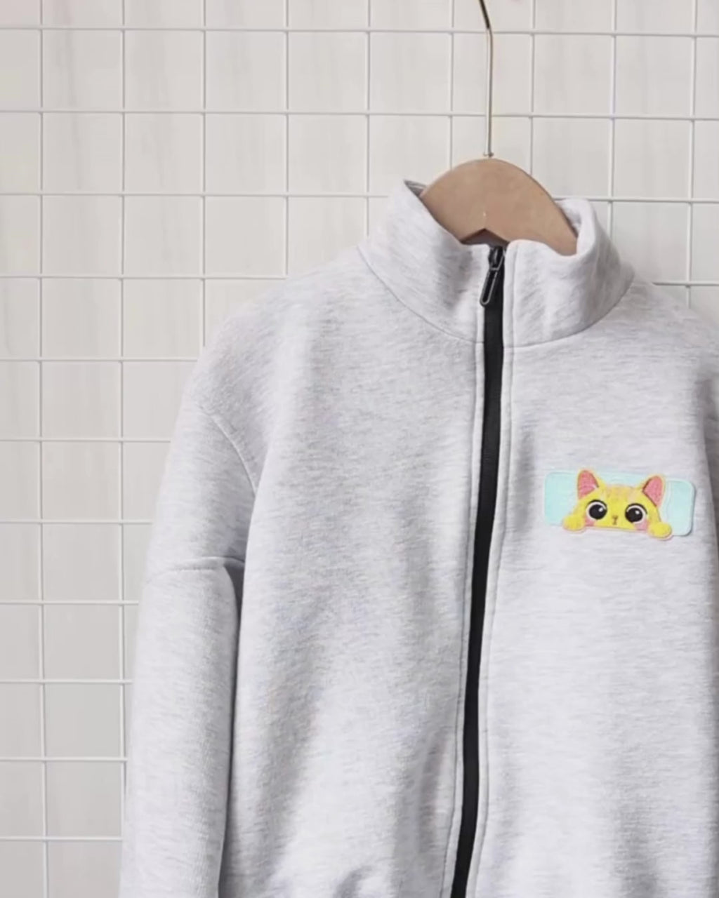 Video of Alwair Kids cotton zip-up jacket for girls showcasing both black and grey color options with embroidered cat patches