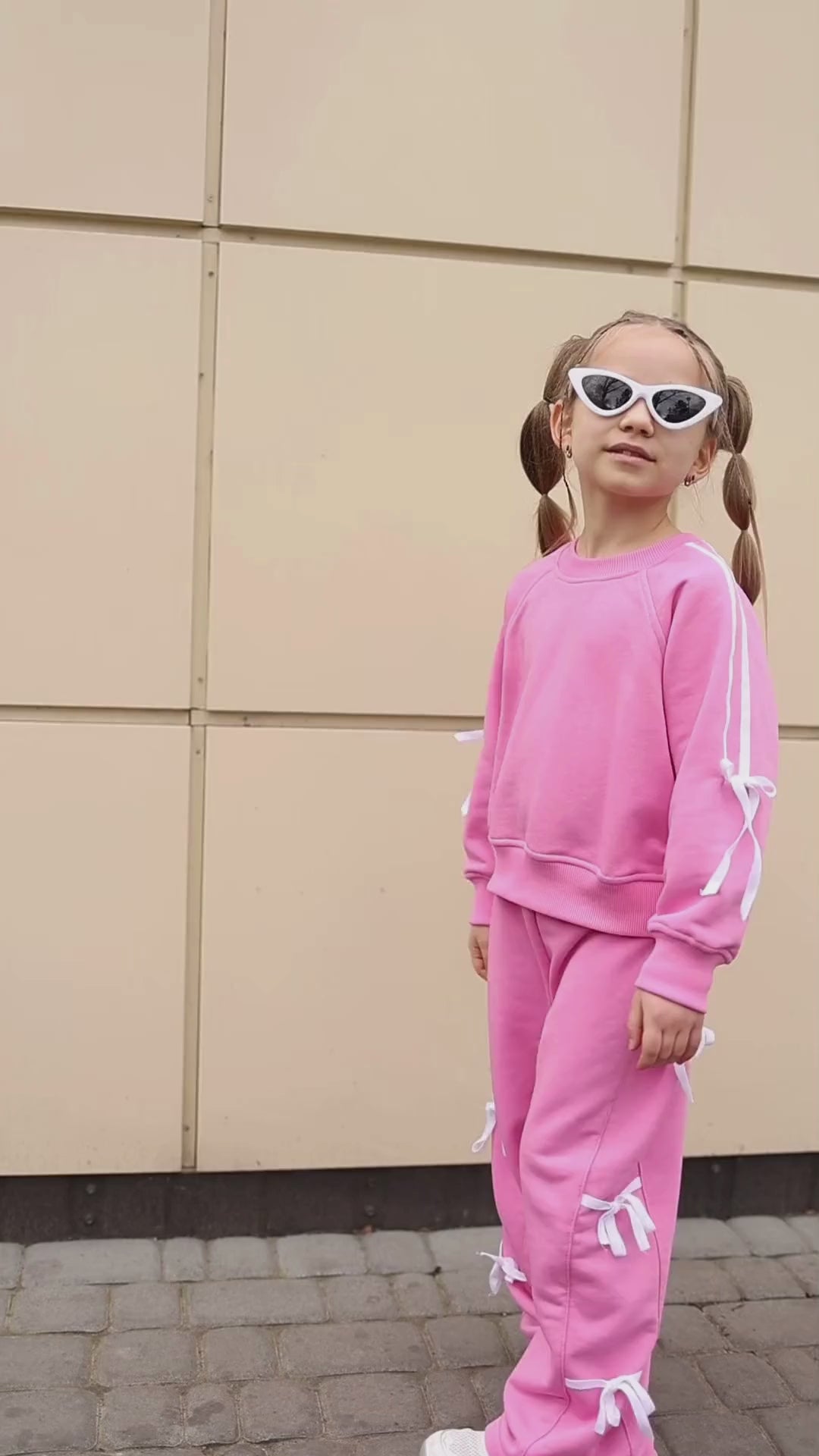 Alwair Kids bow tracksuit on model in motion video