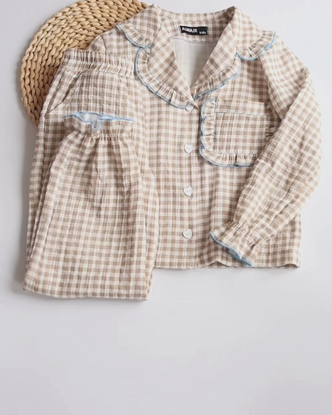 Video of a smiling girl wearing Alwair Kids muslin pajama set with red heart print, showing fit, movement, and soft ruffle details.