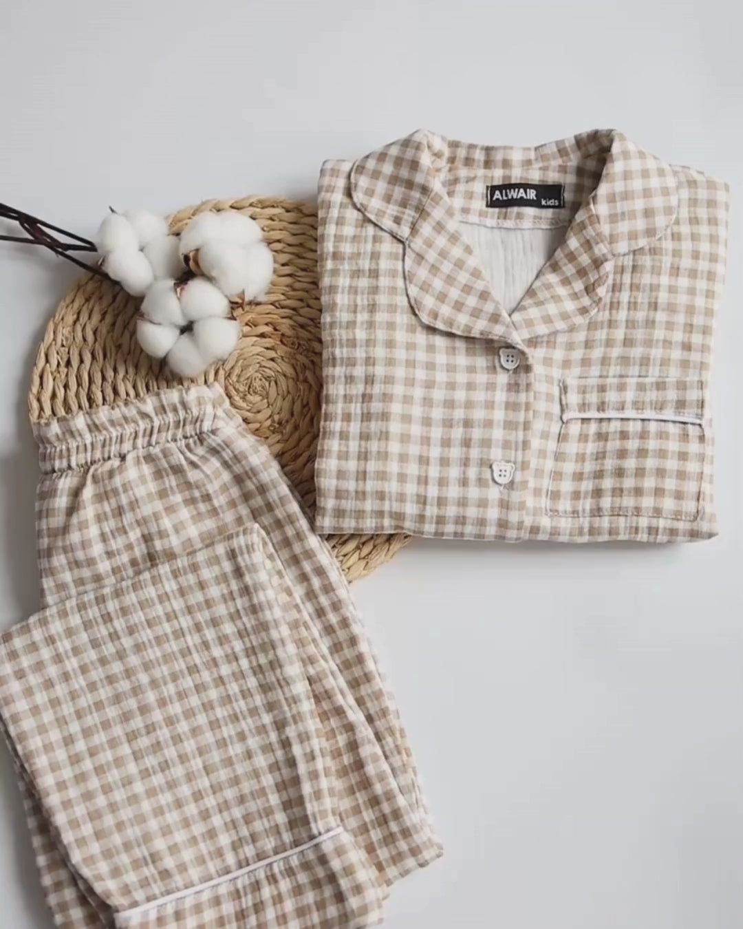 Video showcasing the texture, fit, and fabric softness of Alwair Kids muslin pajama sets in beige and blue